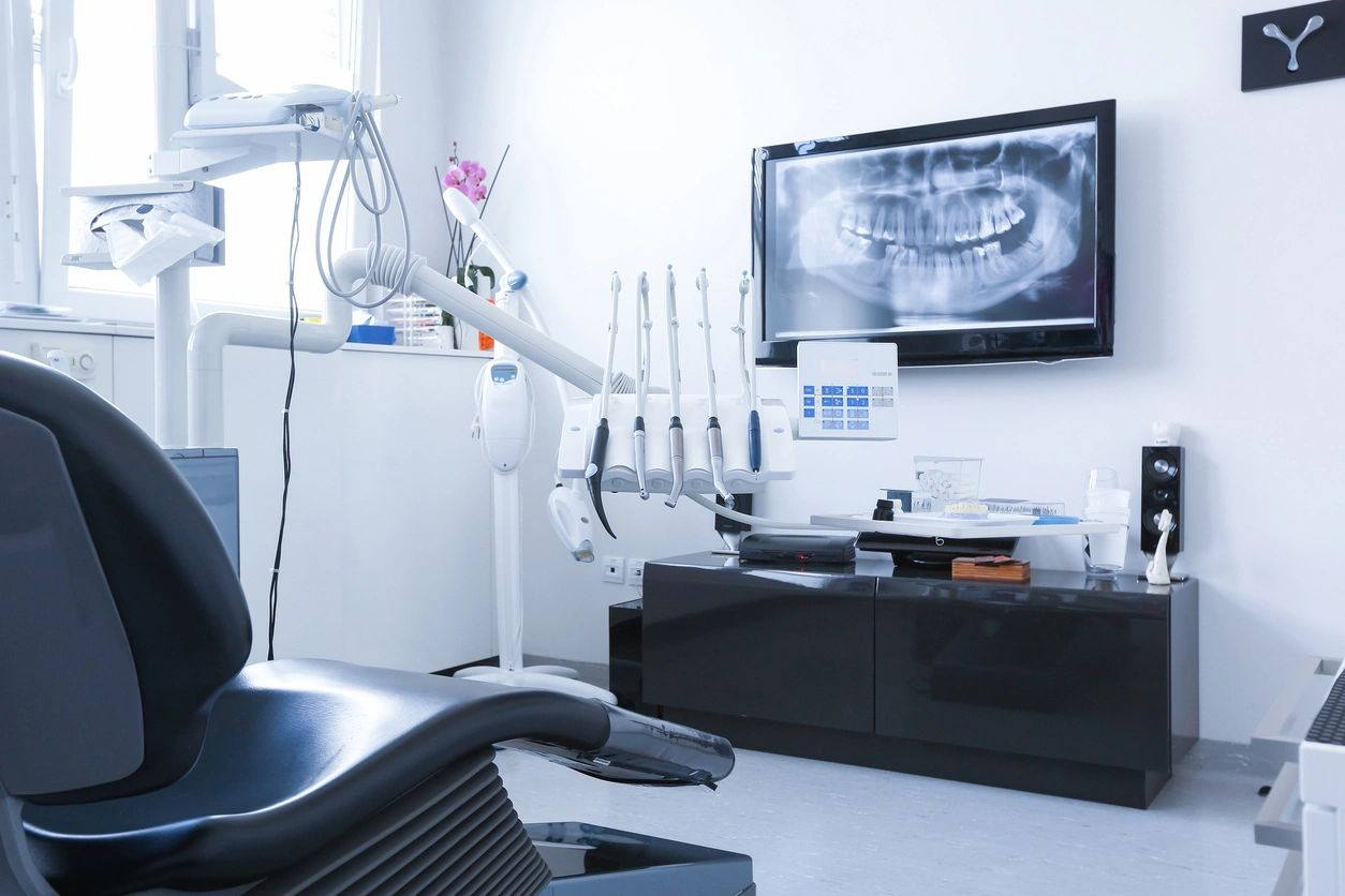 A dentist 's office with an open view of the tv.